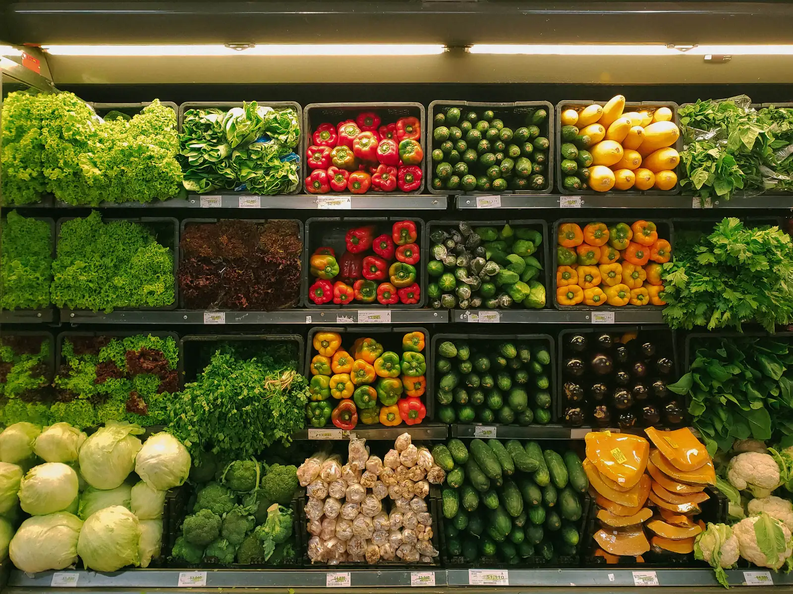 Fresh vegetables laid out on a kitchen table